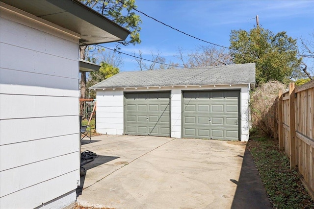 detached garage featuring fence