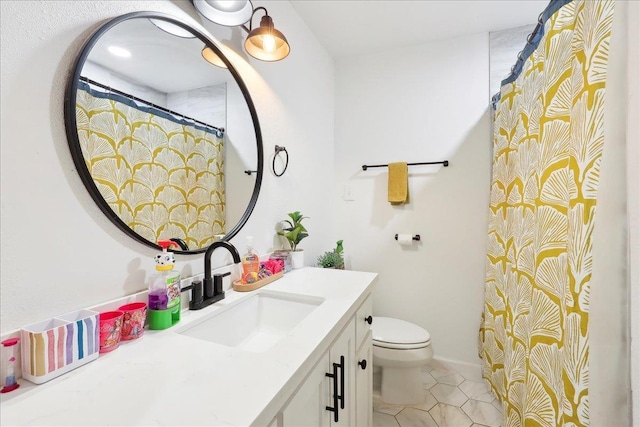 bathroom with vanity, toilet, and tile patterned floors