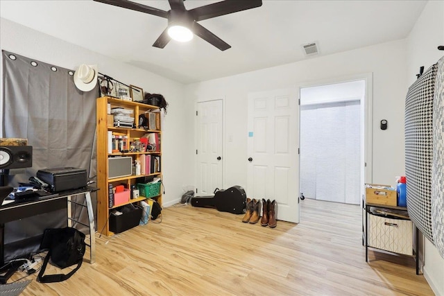 home office featuring ceiling fan, visible vents, and wood finished floors