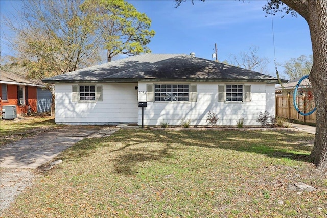 ranch-style house with fence, a front lawn, and central air condition unit