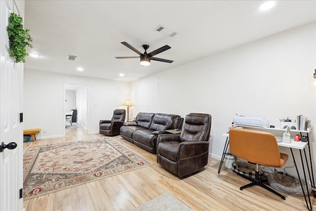 living area with ceiling fan, wood finished floors, and visible vents