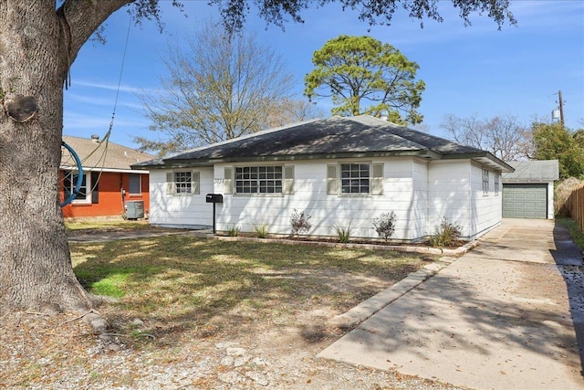 single story home featuring an outbuilding and central AC