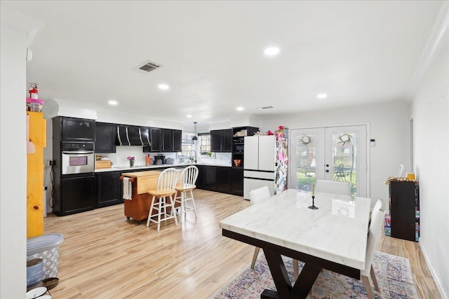 dining area featuring french doors, recessed lighting, visible vents, and light wood-style floors