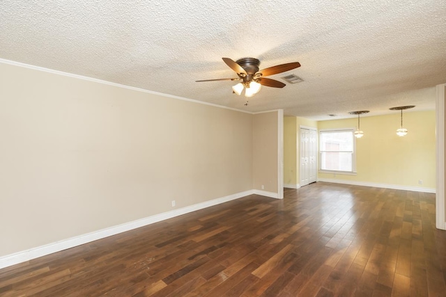 unfurnished room featuring ceiling fan, dark wood-style flooring, visible vents, baseboards, and ornamental molding