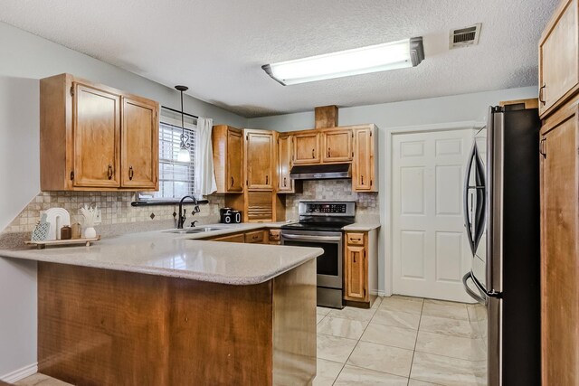 kitchen with sink, kitchen peninsula, pendant lighting, a textured ceiling, and appliances with stainless steel finishes