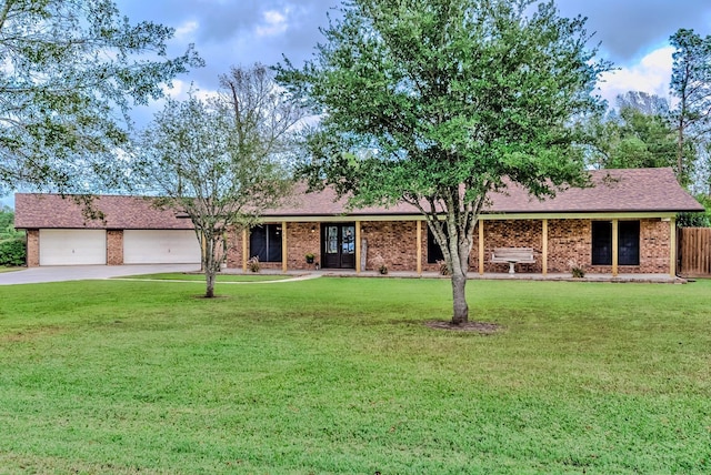 single story home with a garage and a front lawn