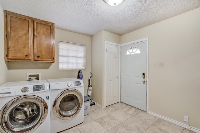 laundry area featuring cabinets, independent washer and dryer, a textured ceiling, and light tile patterned floors