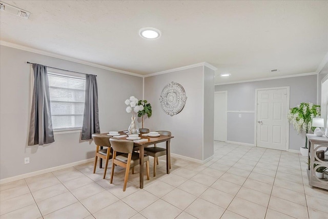 dining space with ornamental molding and light tile patterned floors