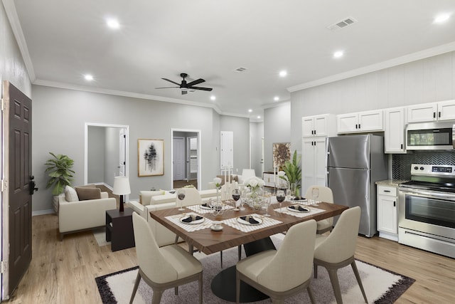 dining room featuring ceiling fan, crown molding, and light hardwood / wood-style flooring