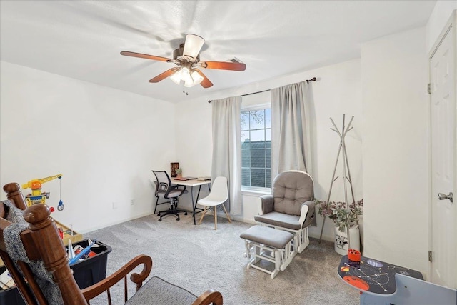 living area with a ceiling fan and carpet