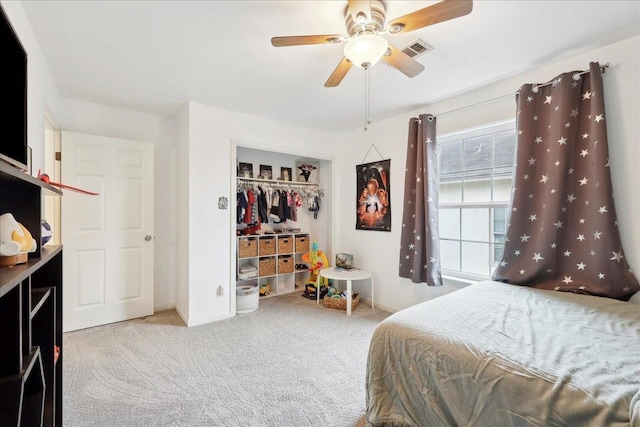 bedroom featuring visible vents, carpet, a closet, and ceiling fan