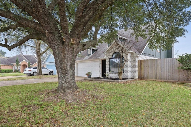 view of front of home with fence, a shingled roof, concrete driveway, a front lawn, and a garage