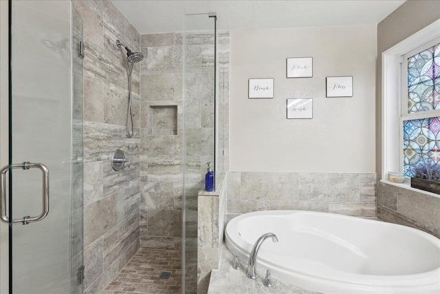 bathroom featuring a stall shower and a garden tub