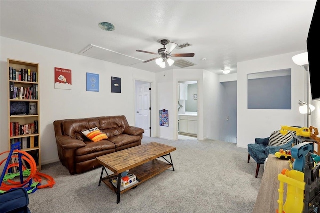 living room featuring attic access, visible vents, carpet floors, and ceiling fan