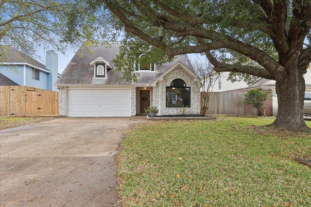 view of front of house featuring stone siding, driveway, a front yard, and fence