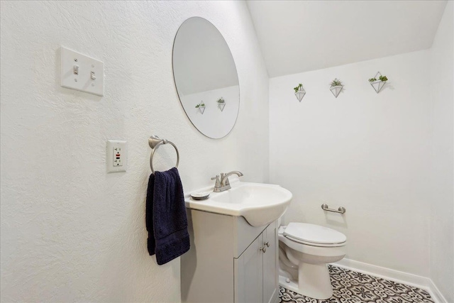 bathroom featuring tile patterned floors, toilet, vanity, and baseboards