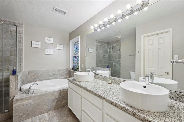 full bath featuring visible vents, double vanity, toilet, a shower stall, and a bath