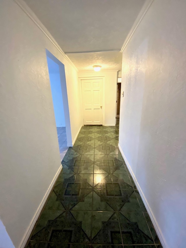 corridor with tile patterned flooring and ornamental molding