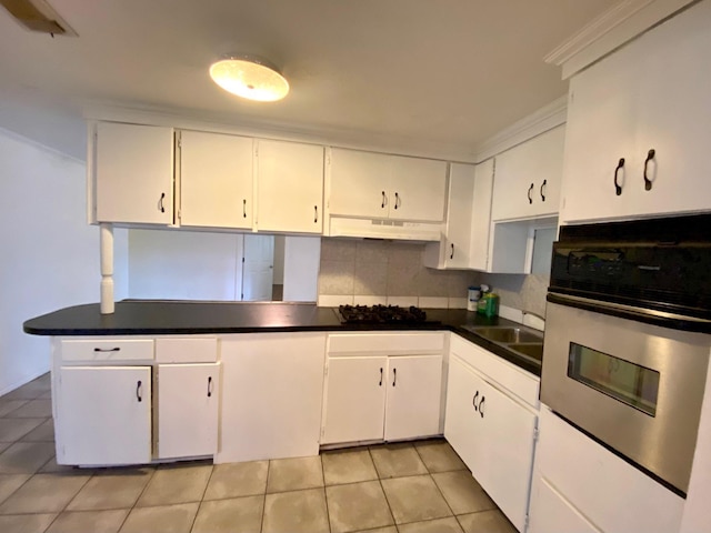 kitchen with white cabinetry, sink, backsplash, oven, and light tile patterned floors