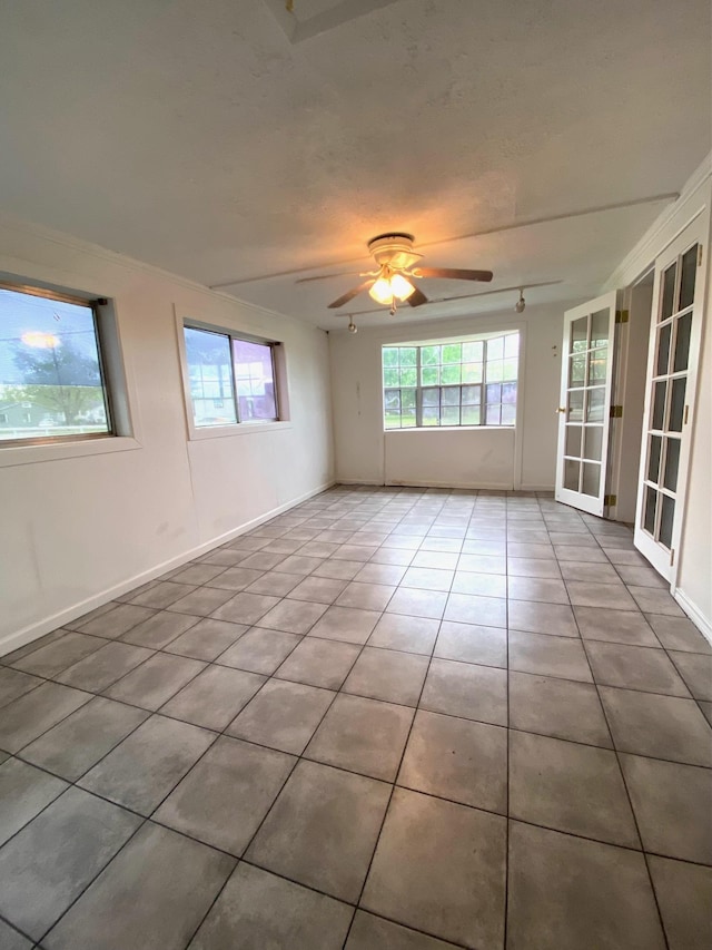 tiled empty room with ceiling fan