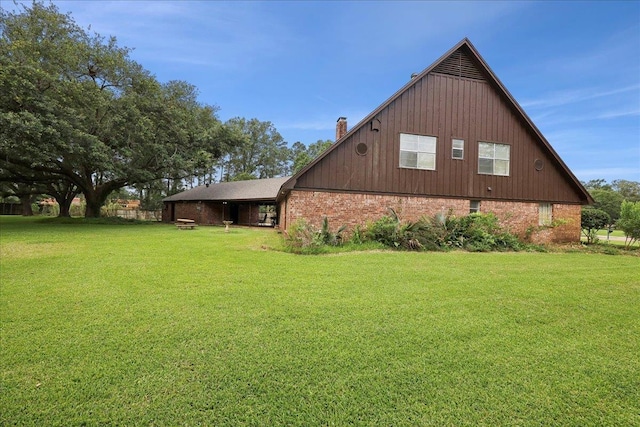 1210 Nottingham Ln, Beaumont, TX 77706 - view of side of property featuring a yard, brick siding, and a chimney