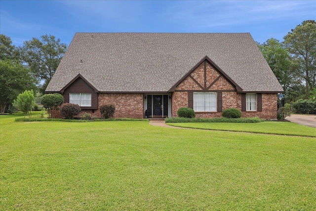 1210 Nottingham Ln, Beaumont, TX 77706 - view of front of house featuring roof with shingles, brick siding, and a front lawn
