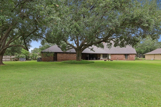 1210 Nottingham Ln, Beaumont, TX 77706 - view of green lawn featuring central air condition unit
