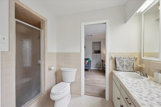 1210 Nottingham Ln, Beaumont, TX 77706 - bathroom with tile walls, vanity, tile patterned floors, wainscoting, and a stall shower