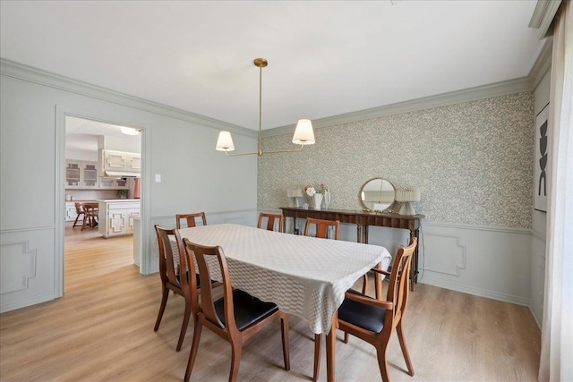 1210 Nottingham Ln, Beaumont, TX 77706 - dining space with a wainscoted wall, ornamental molding, light wood finished floors, and wallpapered walls