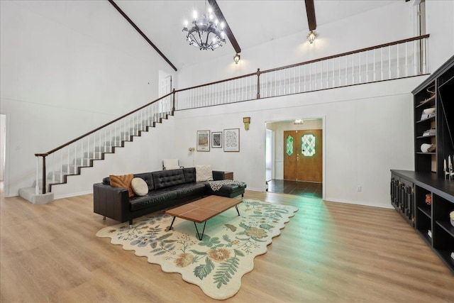 1210 Nottingham Ln, Beaumont, TX 77706 - living room with high vaulted ceiling, stairway, wood finished floors, a chandelier, and baseboards