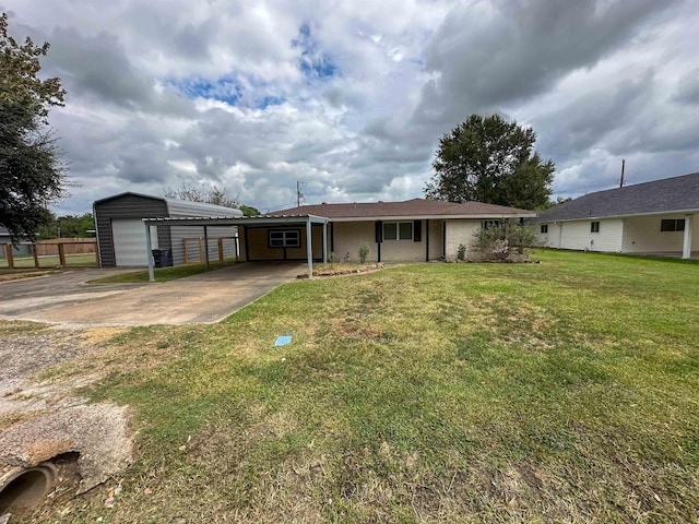 view of front of property featuring an outbuilding, a front lawn, a carport, and a garage