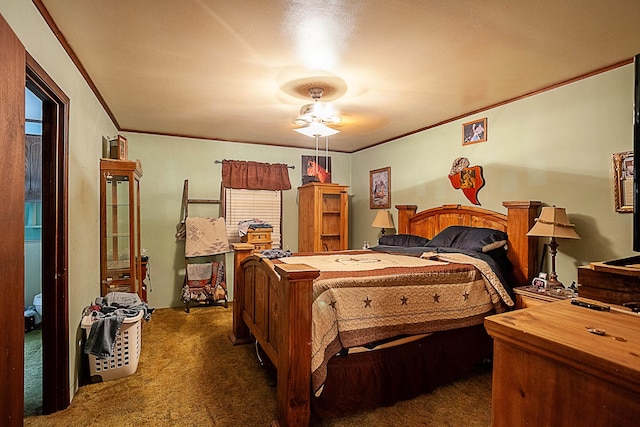 carpeted bedroom featuring ornamental molding and a ceiling fan