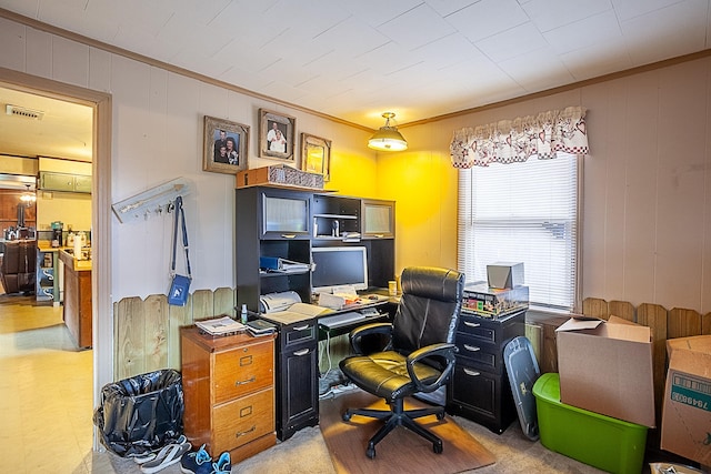 office space with visible vents, light carpet, and crown molding