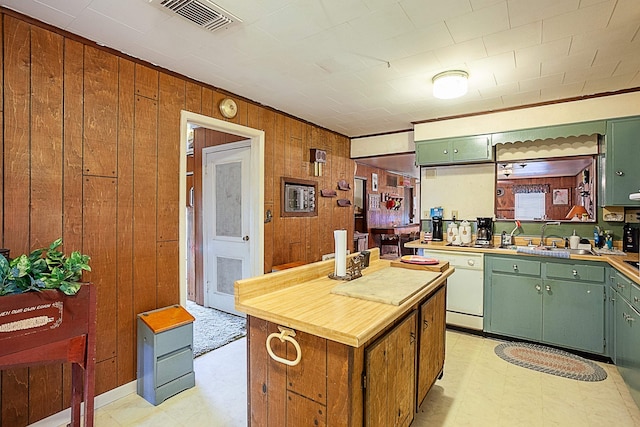 kitchen featuring dishwasher, light floors, visible vents, and green cabinetry