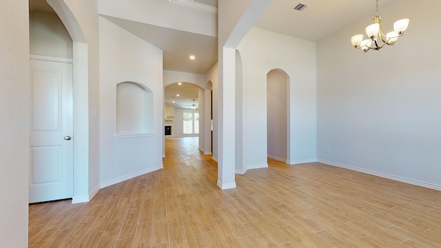 225 Sycamore Ct, Lumberton, TX 77657 - spare room featuring light wood-style floors, a chandelier, a fireplace, and recessed lighting