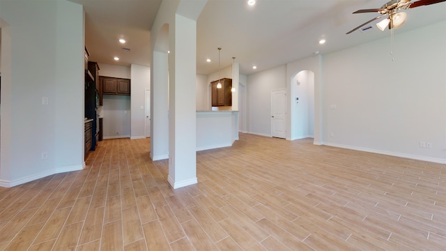 225 Sycamore Ct, Lumberton, TX 77657 - unfurnished living room with arched walkways, ceiling fan, light wood finished floors, and recessed lighting