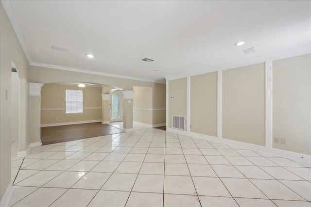 5210 Ada Ave, Beaumont, TX 77708 - spare room with decorative columns, arched walkways, ornamental molding, baseboards, and light tile patterned floors