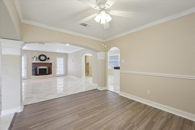 5210 Ada Ave, Beaumont, TX 77708 - unfurnished living room with ceiling fan, light wood finished floors, a fireplace, ornamental molding, and baseboards