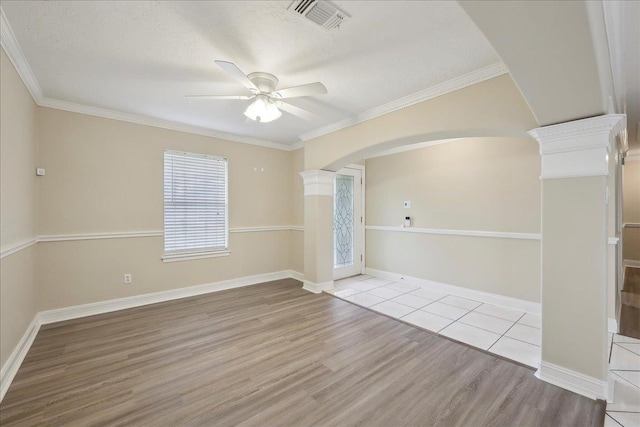 5210 Ada Ave, Beaumont, TX 77708 - empty room with wood finished floors, ceiling fan, ornate columns, arched walkways, and crown molding