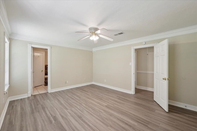 5210 Ada Ave, Beaumont, TX 77708 - unfurnished bedroom featuring light wood-type flooring, ornamental molding, baseboards, a ceiling fan, and ensuite bathroom