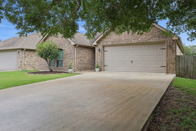 view of front of home featuring brick siding, concrete driveway, an attached garage, and fence