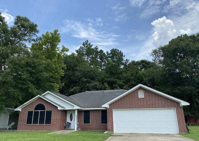 single story home with a garage and a front lawn