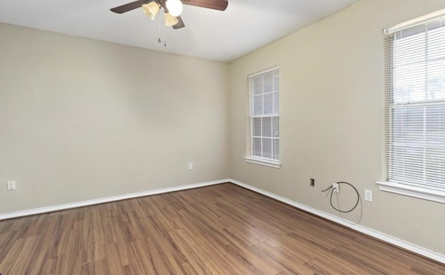 spare room with hardwood / wood-style floors and ceiling fan