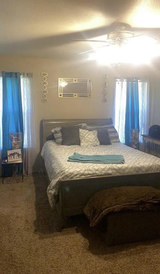 bedroom with ceiling fan and carpet flooring