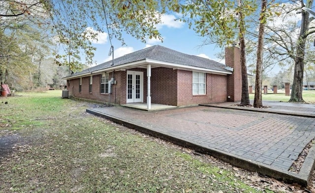 back of house with a patio, a yard, cooling unit, and french doors