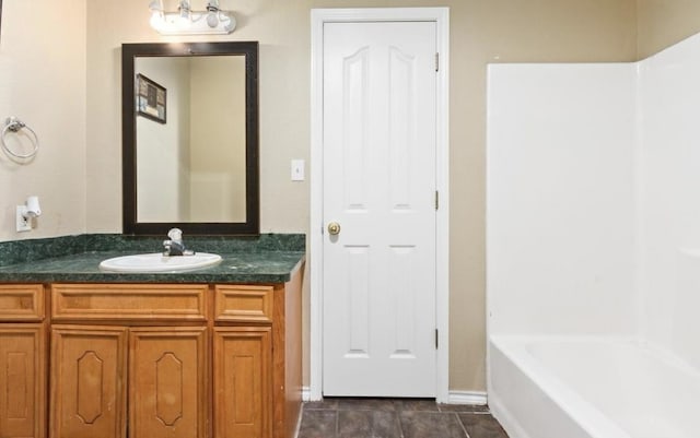 bathroom with vanity, tub / shower combination, and tile patterned flooring