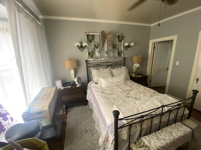 bedroom with carpet, ceiling fan, and crown molding