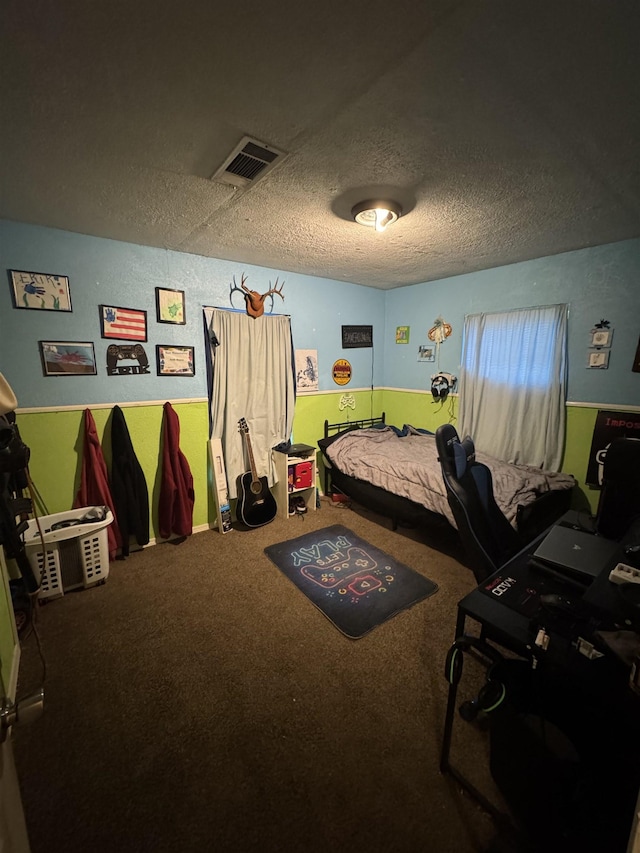 carpeted bedroom featuring visible vents and a textured ceiling