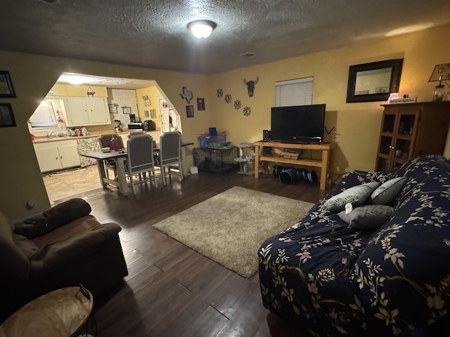 living room featuring a textured ceiling and light wood finished floors