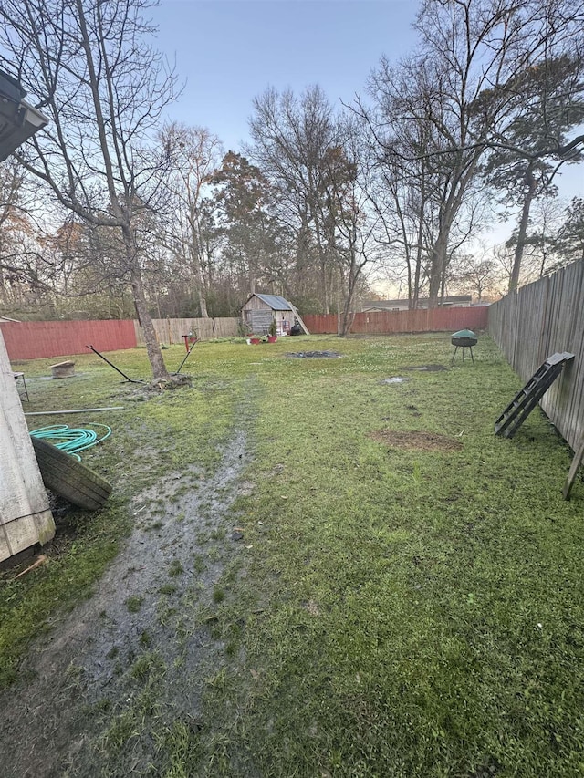 view of yard featuring fence private yard and an outdoor structure